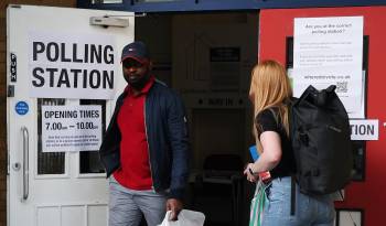 Votantes salen de un colegio electoral el día de las elecciones generales en Londres, Reino Unido.