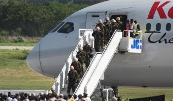 Soldados kenianos descienden de un avión este 25 de junio de 2024, en el aeropuerto Toussaint Louverture de Puerto Príncipe (Haití).