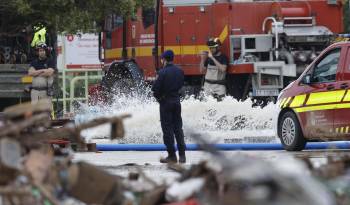 Bomberos y policía Nacional continúan en los trabajos de achique y búsqueda en el parking de Bonaire en Aldaia, Valencia, este lunes.