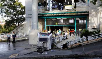 Police officers guard the site where a Metrocable cable railway cabin fell after derailing at one of the stations in Medellin, Colombia, on June 26, 2024.