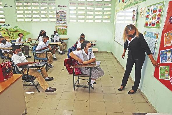 Una docente imparte clases presenciales.