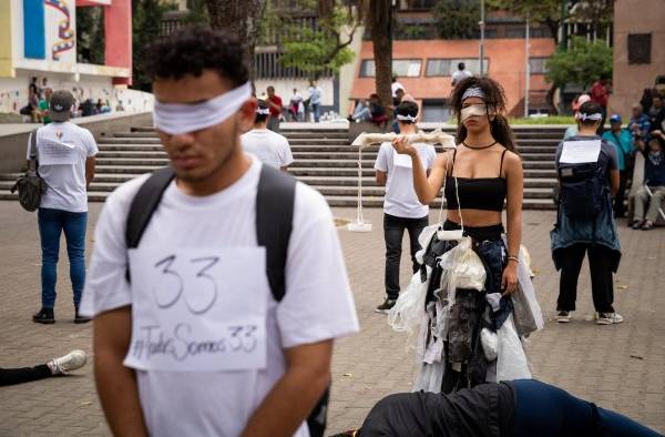 Activistas participan hoy, en una protesta contra la criminalización de la comunidad LGBT, en Caracas (Venezuela)