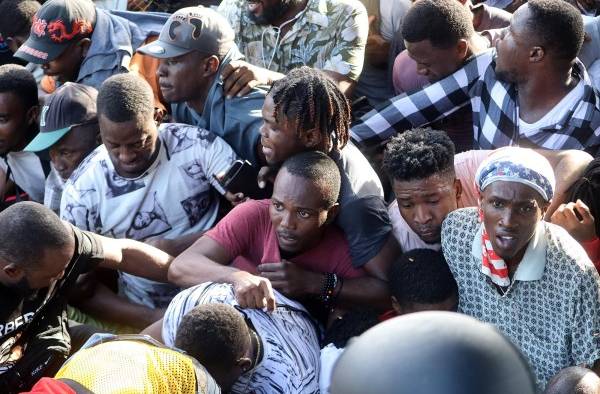 Grupos de migrantes rompen el cerco de seguridad durante una manifestación frente a las instalaciones de la Comisión Mexicana de Ayuda a Refugiados (Comar), hoy, en Tapachula, estado de Chiapas (México).