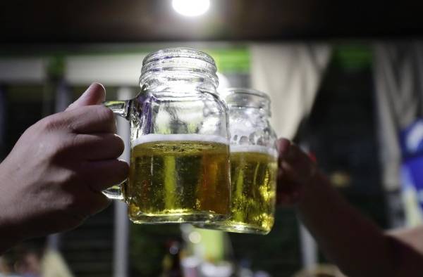 Dos hombres beben cerveza en una cervecería, el 1 de septiembre de2023, en San Salvador (El Salvador).