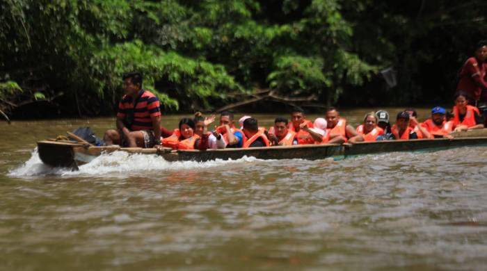 Migrantes irregulares cruzando por el Darién.