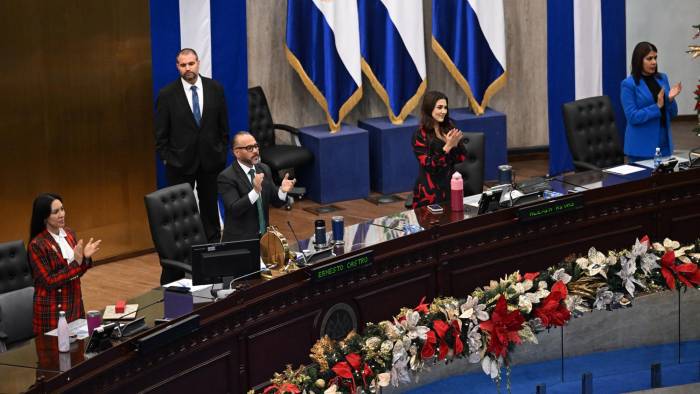 El presidente del Congreso de El Salvador y miembro del partido gobernante, Ernesto Castro (3er desde la izquierda), asiste a una sesión para aprobar un proyecto de ley que revoca la prohibición de la minería metálica.