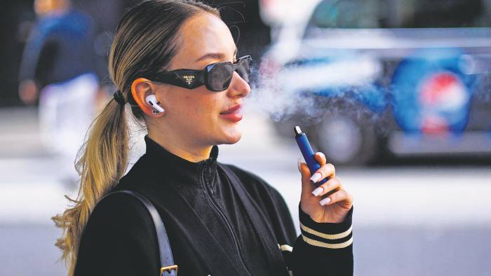 Una mujer utiliza un vapeador