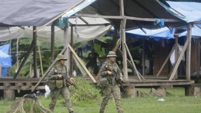 Integrantes del Servicio Nacional de Fronteras resguardan un campamento en medio de un operativo este 31 de agosto en plena selva del Darién, frontera natural entre Colombia y Panamá.