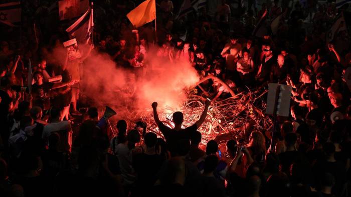 Manifestantes que apoyan a las familias de los rehenes israelíes retenidos por Hamás en Gaza encienden hogueras mientras bloquean la carretera principal de Ayalon, durante una protesta en Tel Aviv, Israel, el 1 de septiembre de 2024.