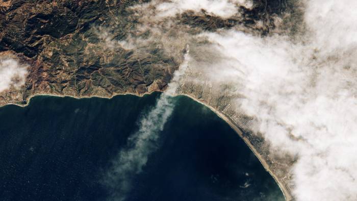 Una imagen satelital proporcionada por el Observatorio de la Tierra de la NASA muestra el humo de los incendios forestales y las nubes sobre Los Ángeles, California.