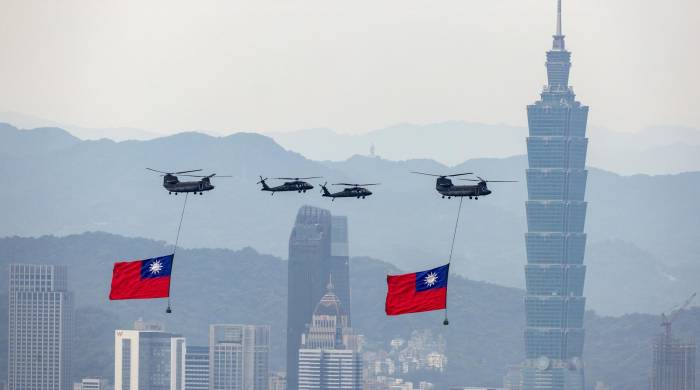 Los helicópteros Chinook de la Fuerza Aérea de Taiwán portan banderas nacionales mientras realizan un sobrevuelo durante un ensayo antes de la toma de posesión del presidente electo William Lai en Taipei, Taiwán, el 17 de mayo de 2024.