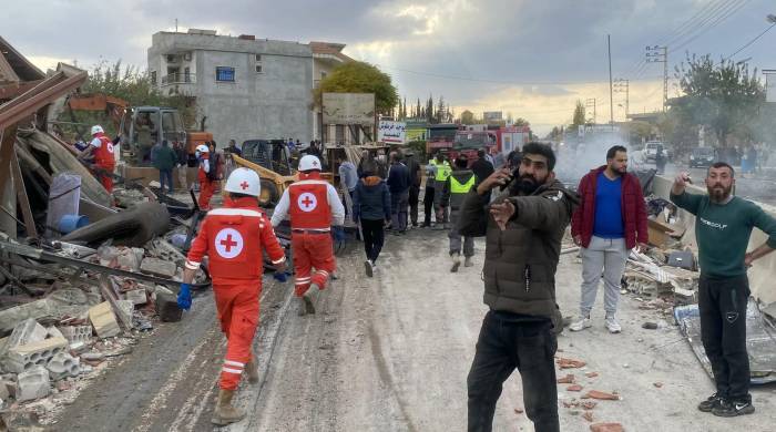 Rescatistas de la Cruz Roja Libanesa buscan víctimas y sobrevivientes en el lugar de un ataque aéreo israelí.