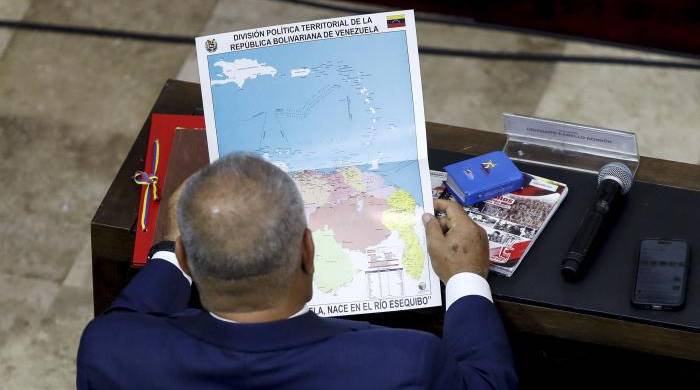 El diputado de la Asamblea Nacional Diosdado Cabello revisa el nuevo mapa de Venezuela con la anexión del territorio de Esequibo..