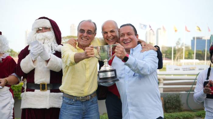 Carlos de Oliveira Jr. (c) hizo entrega de la copa del triunfo a Alfonso Arias (i) y Manuel Grimaldo (d).