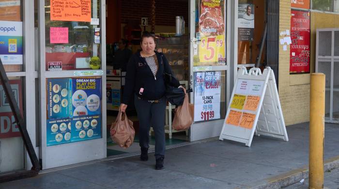 Una persona sale de realizar compras en Los Ángeles, EE.UU.