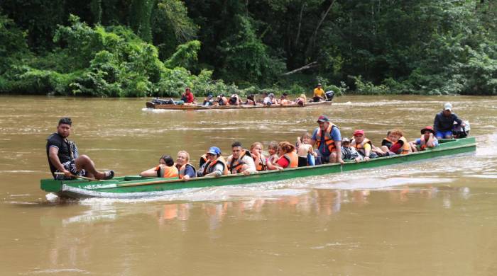 Migrantes llegan en canoa por el río Tuquesa desde el poblado de Bajo Chiquito hasta el centro de recepción de Lajas Blancas en el Darién.